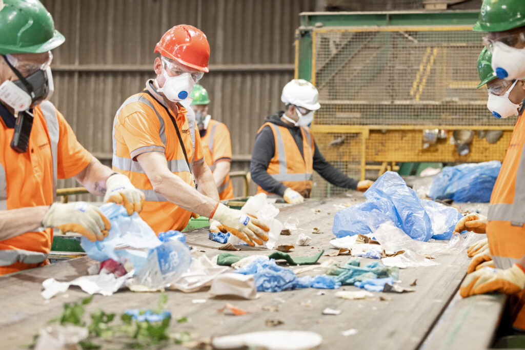 Workers sorting recycling